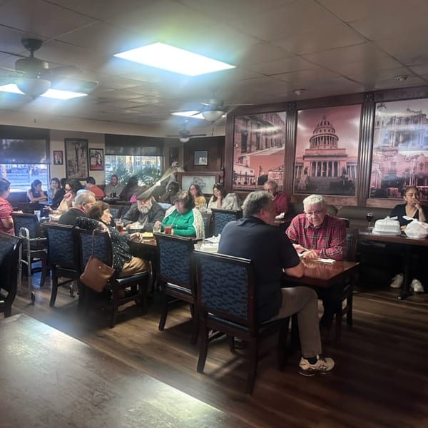 Diners seated at tables in the Havana Club Restaurant & Bar, with large murals of Cuban landmarks.