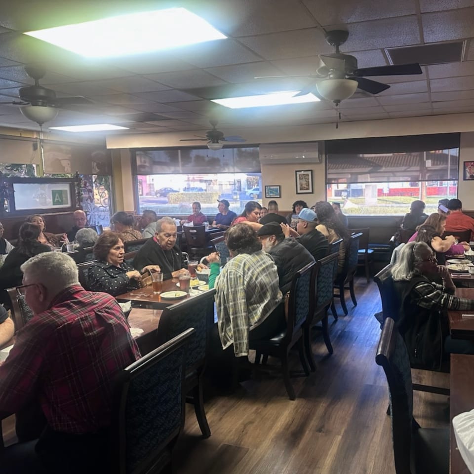 Diners enjoying meals and conversation at tables inside the Havana Club Restaurant & Bar.