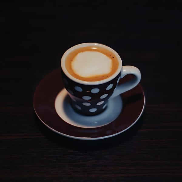 A Havana Club Restaurant & Bar espresso with foamed milk in a polka dot cup and saucer.